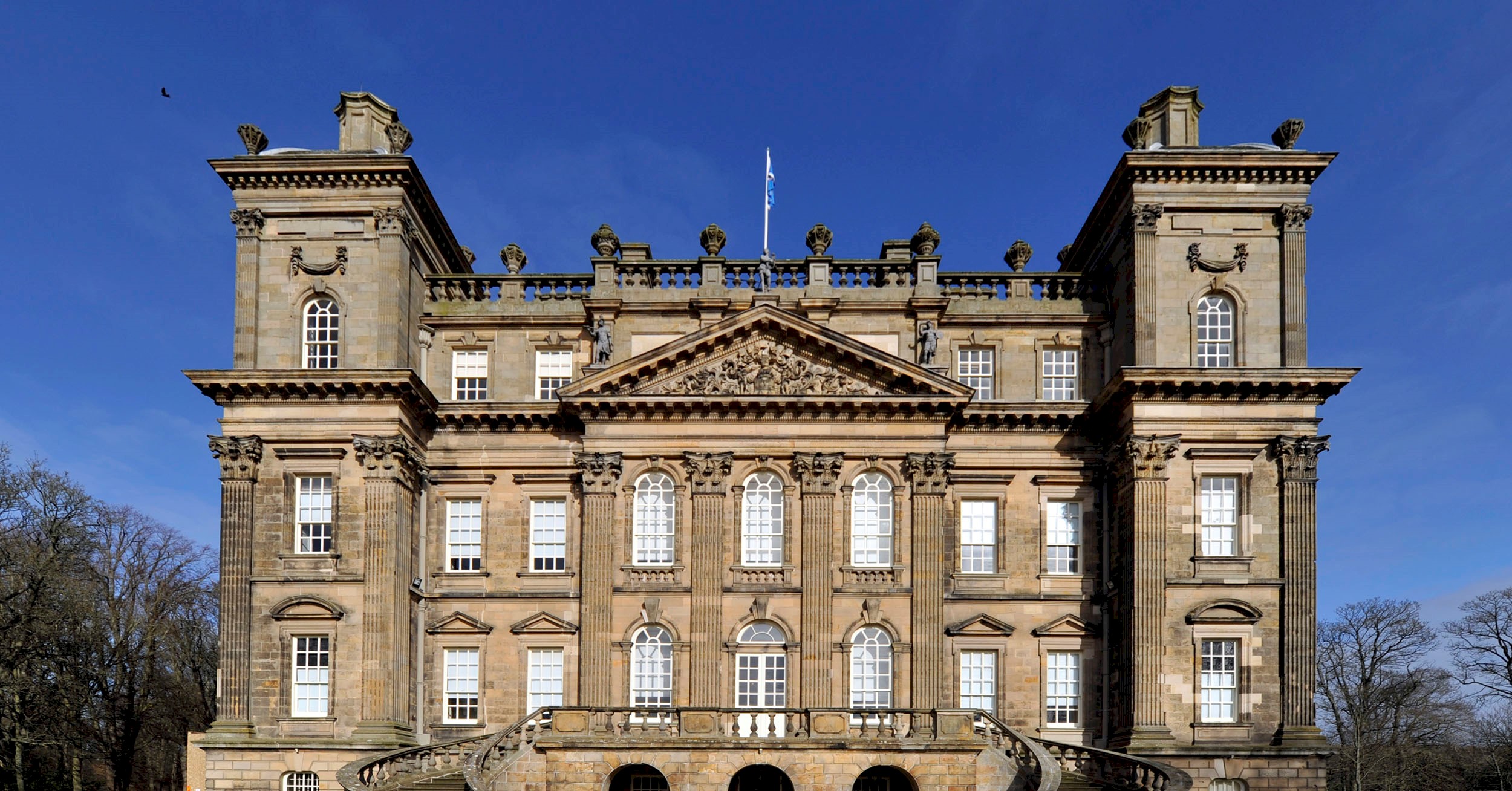 Exterior view of a splendid baroque mansion bathed in blue sky
